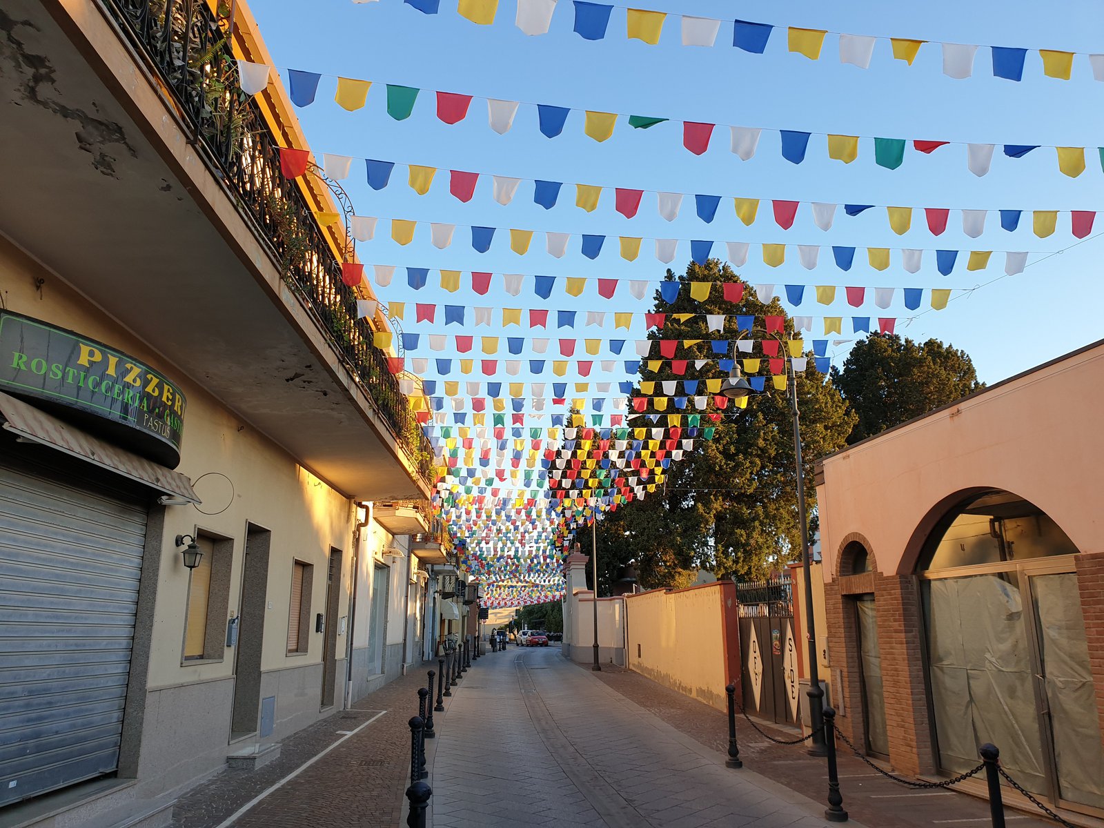 Pula historic town center street with vibrant bougainvillea and outdoor trattorias